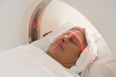 A man gradually being pulled into the MRI