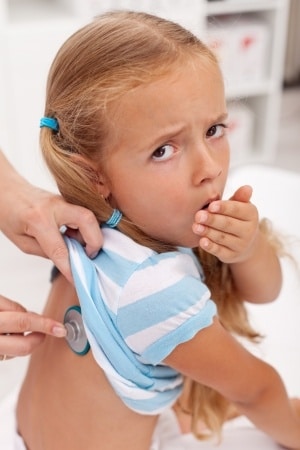 A child coughing and being examined