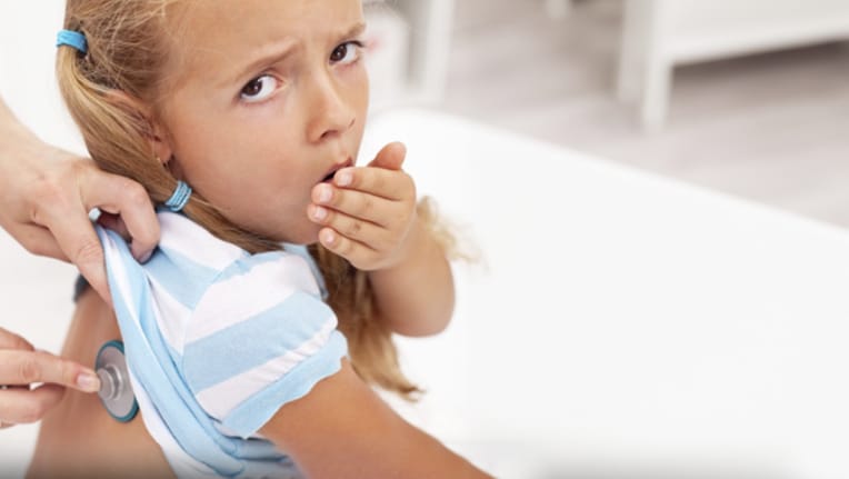 a little girl coughing