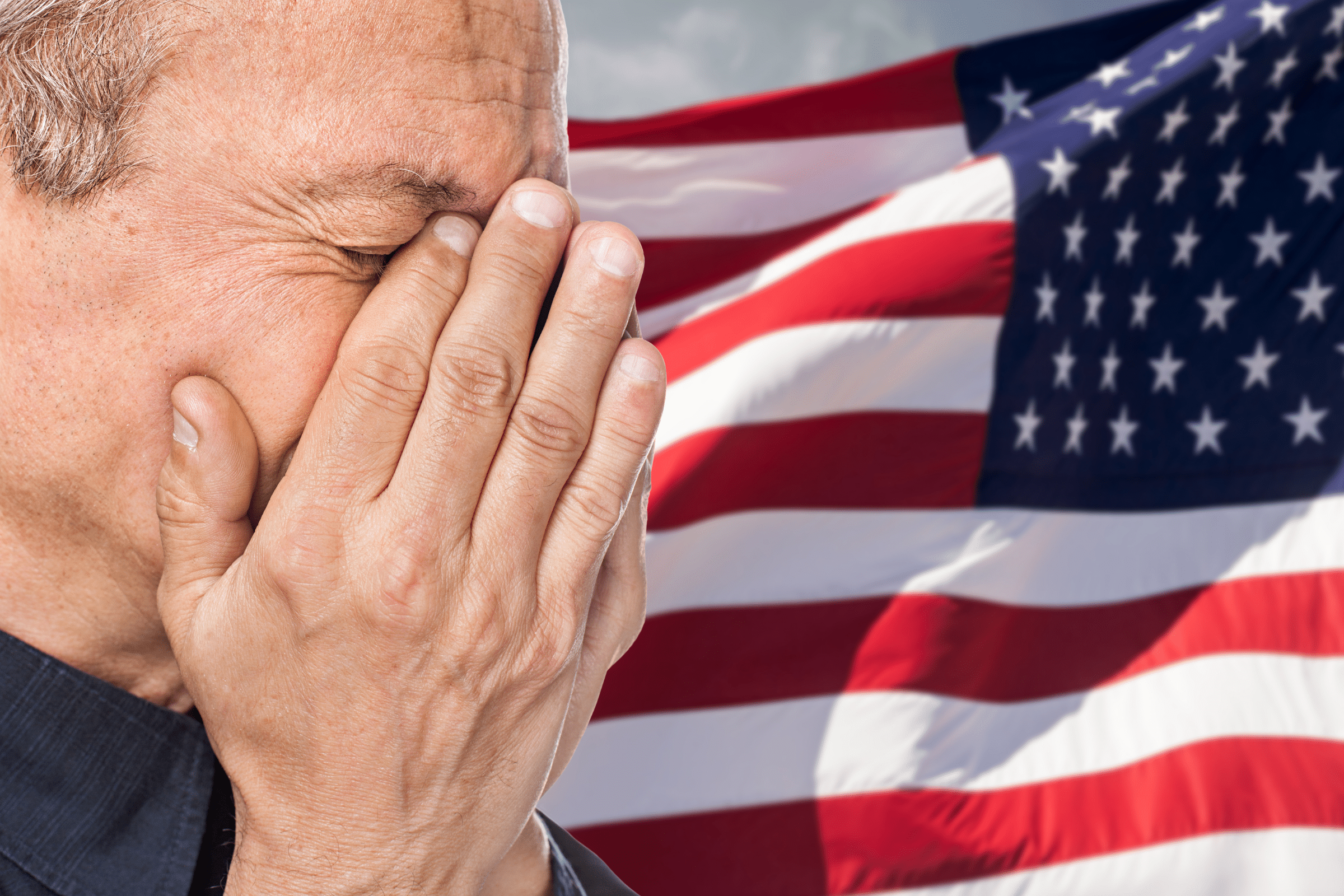Veteran with mesothelioma crying beside the American flag